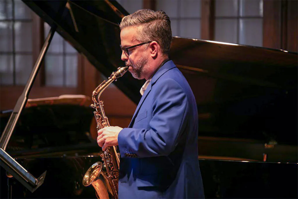Profile of man playing saxophone