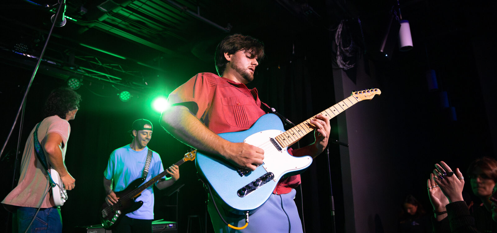 Closeup of lead guitarist on stage during performance