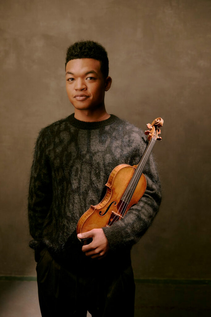 Young man holding violin.