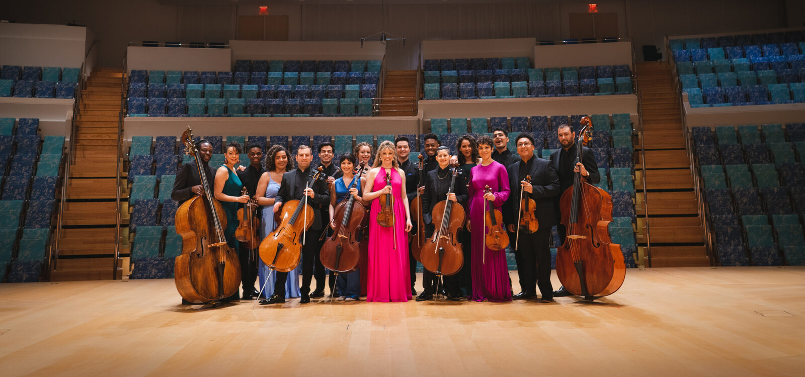 Members of string ensemble posed on stage