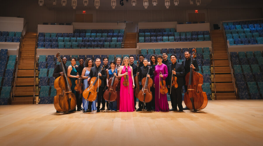Members of string ensemble posed on stage