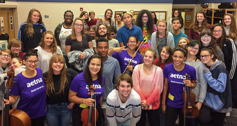 Sphinx Virtuosi posing with students in classroom.