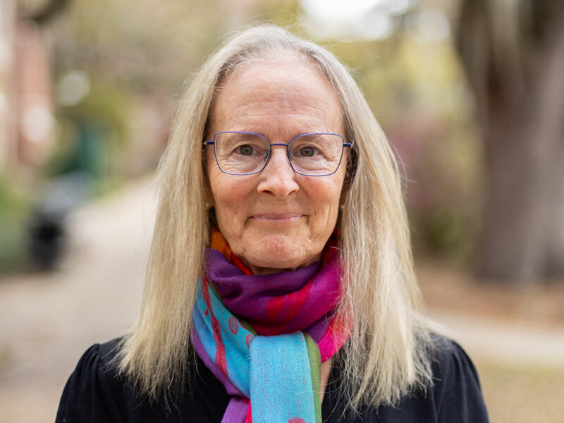 Photo of smiling woman standing outdoors