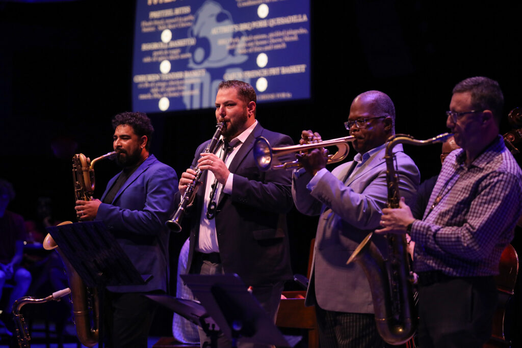 Four jazz musicians on stage in a dark room