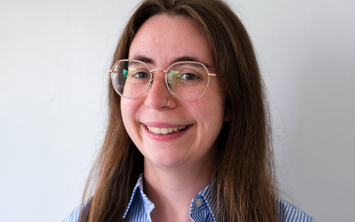 Bespectacled young woman smiling at camera