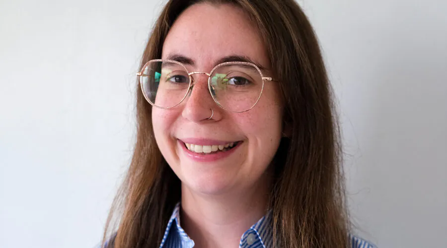 Bespectacled young woman smiling at camera