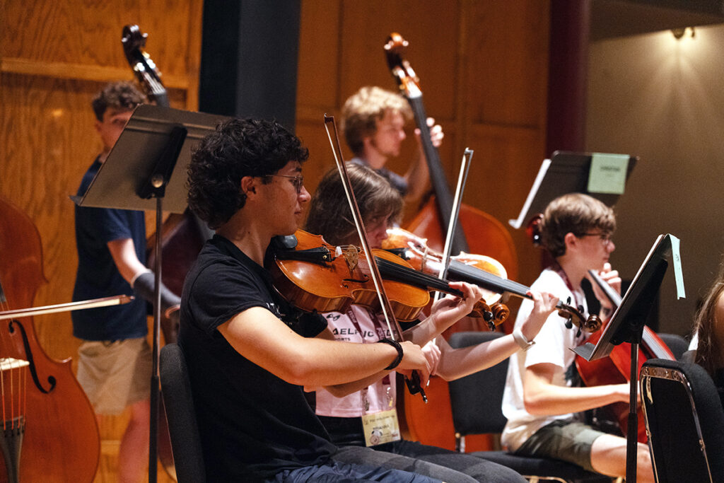Young string student performing on stage