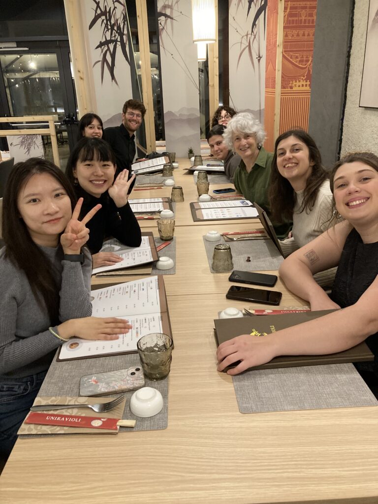 group of smiling men and women at asian restaurant