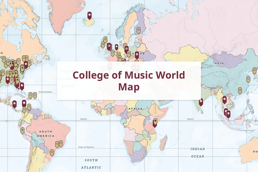 map of the globe with garnet and gold pins