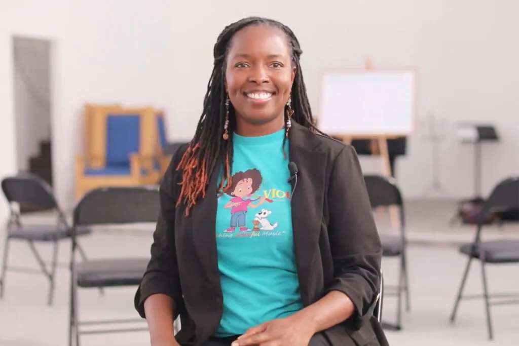 smiling woman seated in classroom
