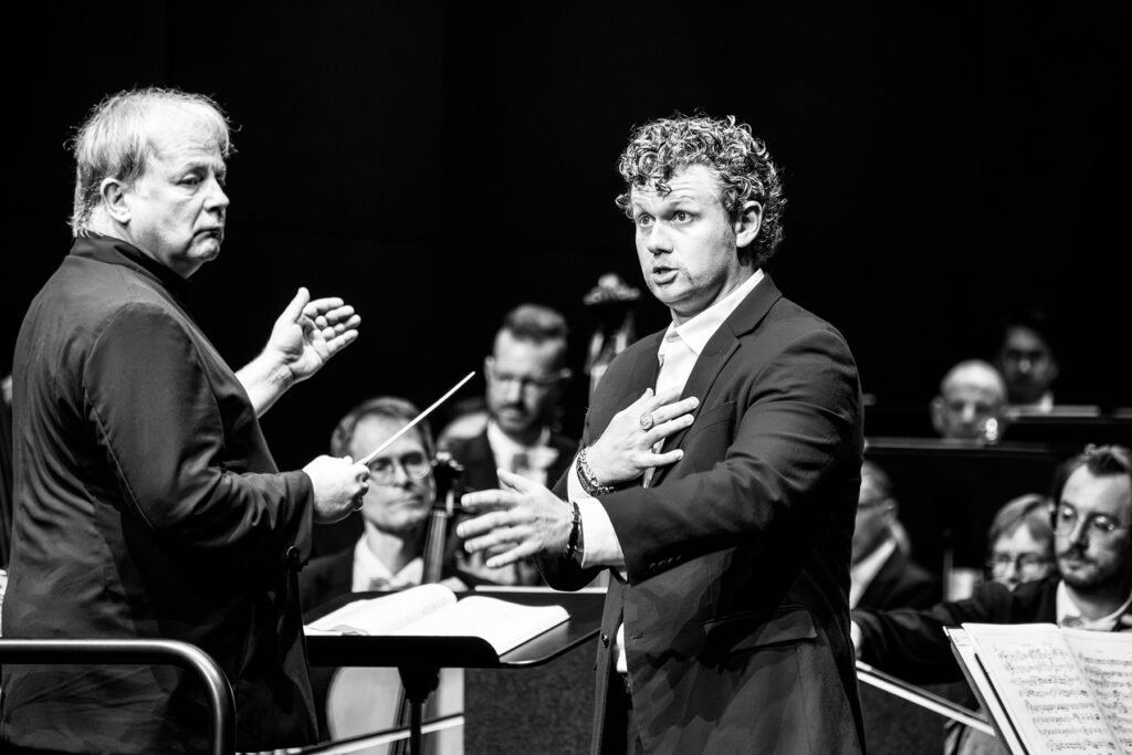 Singer on stage with orchestra during perofrmance