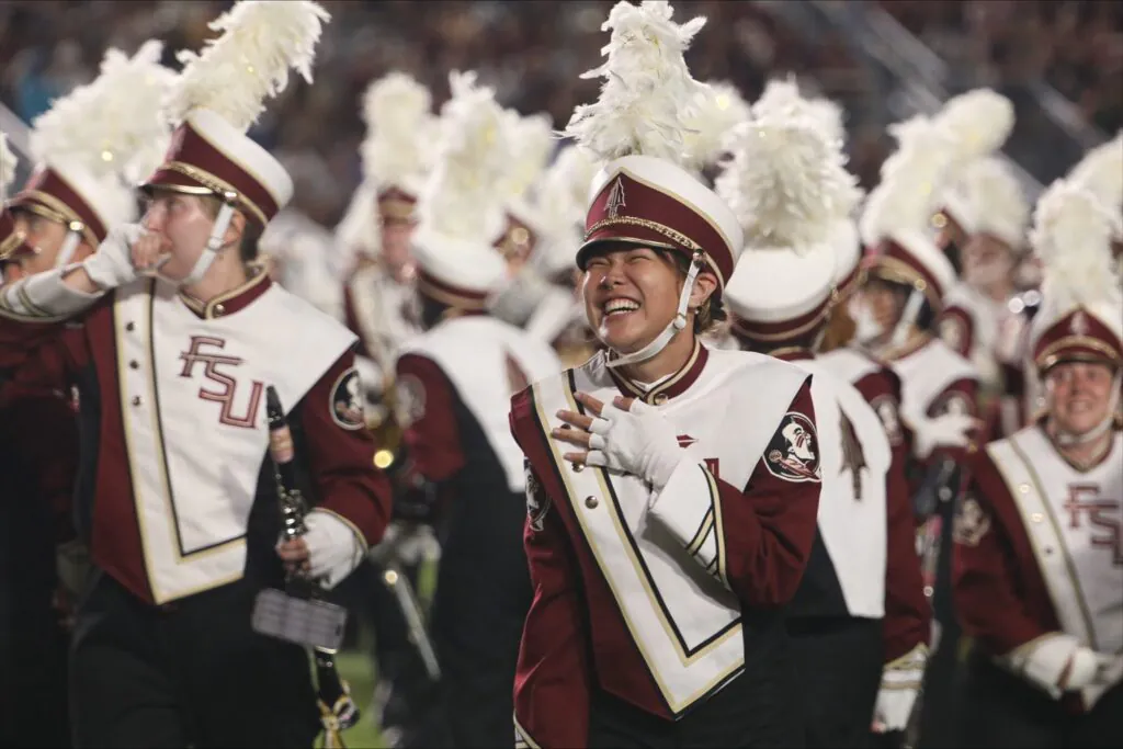 Marching band members react to surprise on field