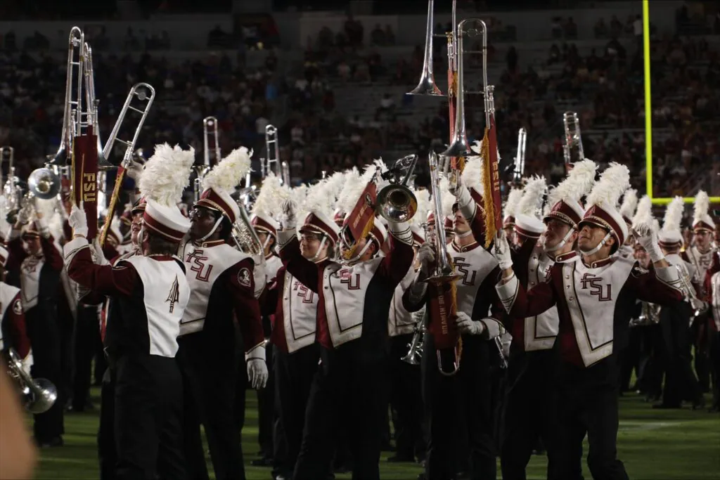 Marching band members celebrate on field