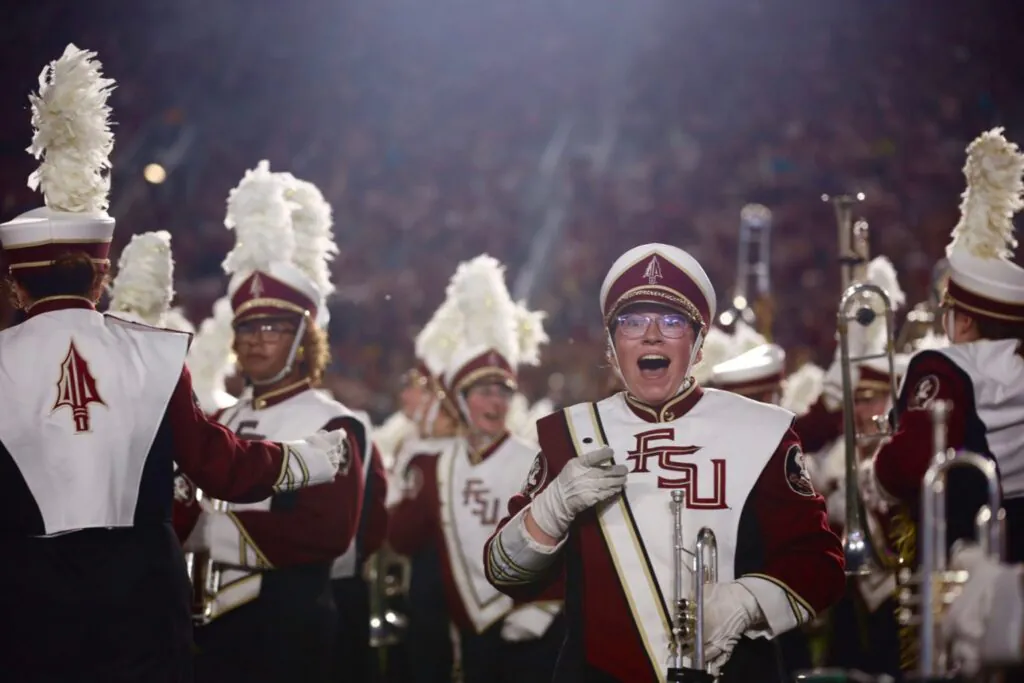 Marching band members react to surprise on field