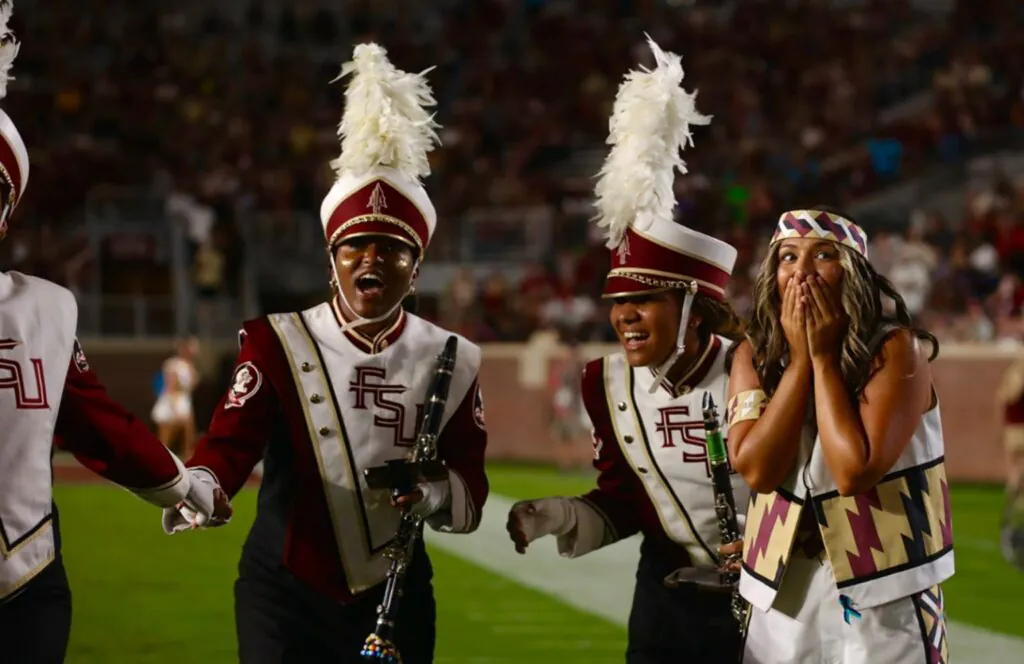 Marching band members react to surprise on field