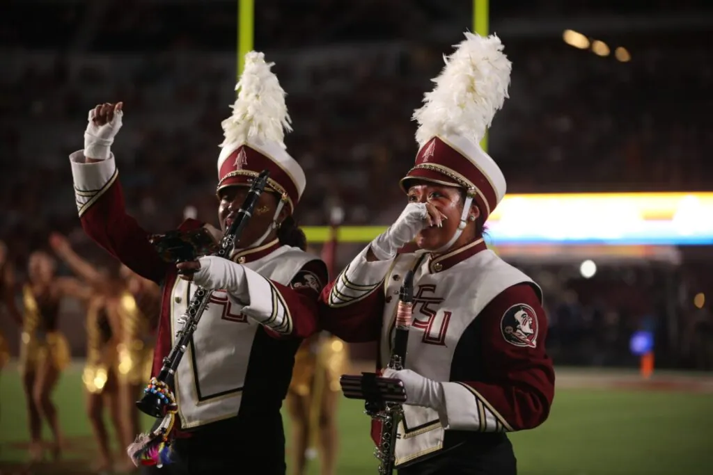 Band members respond to surprise announcement on football field